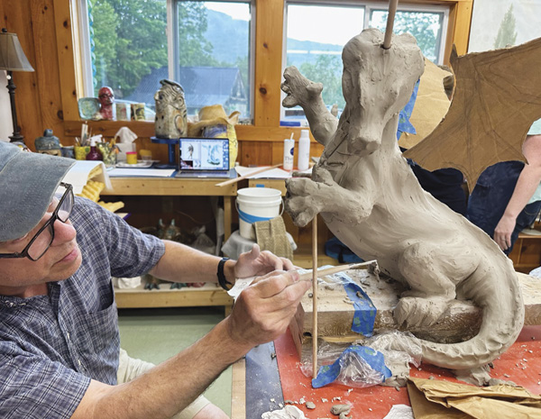 9 Chris Schmidt working on his dragon sculpture during Ariel Bowman’s 2023 Animals in Clay workshop.