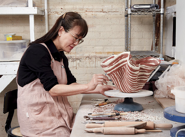 10 Hongmi Kim Hoog during her residency at Greenwich House Pottery, March 6–April 21, 2023. Photo: Alan Wiener, courtesy of Greenwich House Pottery, 2023. Residency venue: Greenwich House Pottery, New York, New York.