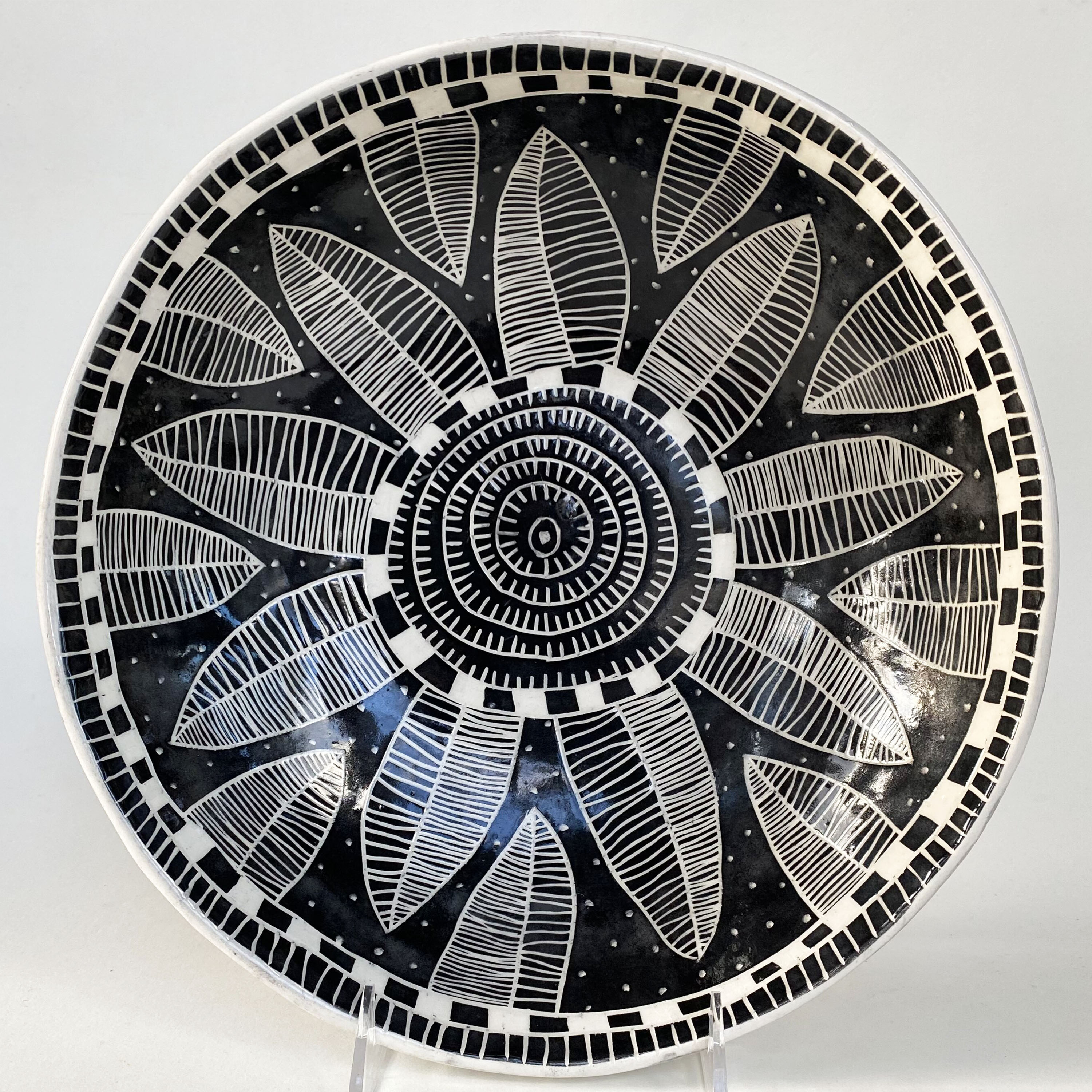 Andryea Natkin’s large flower bowl, 11 in. (28 cm) in diameter, earthenware, black underglaze, satin clear glaze, fired to cone 6, 2020.