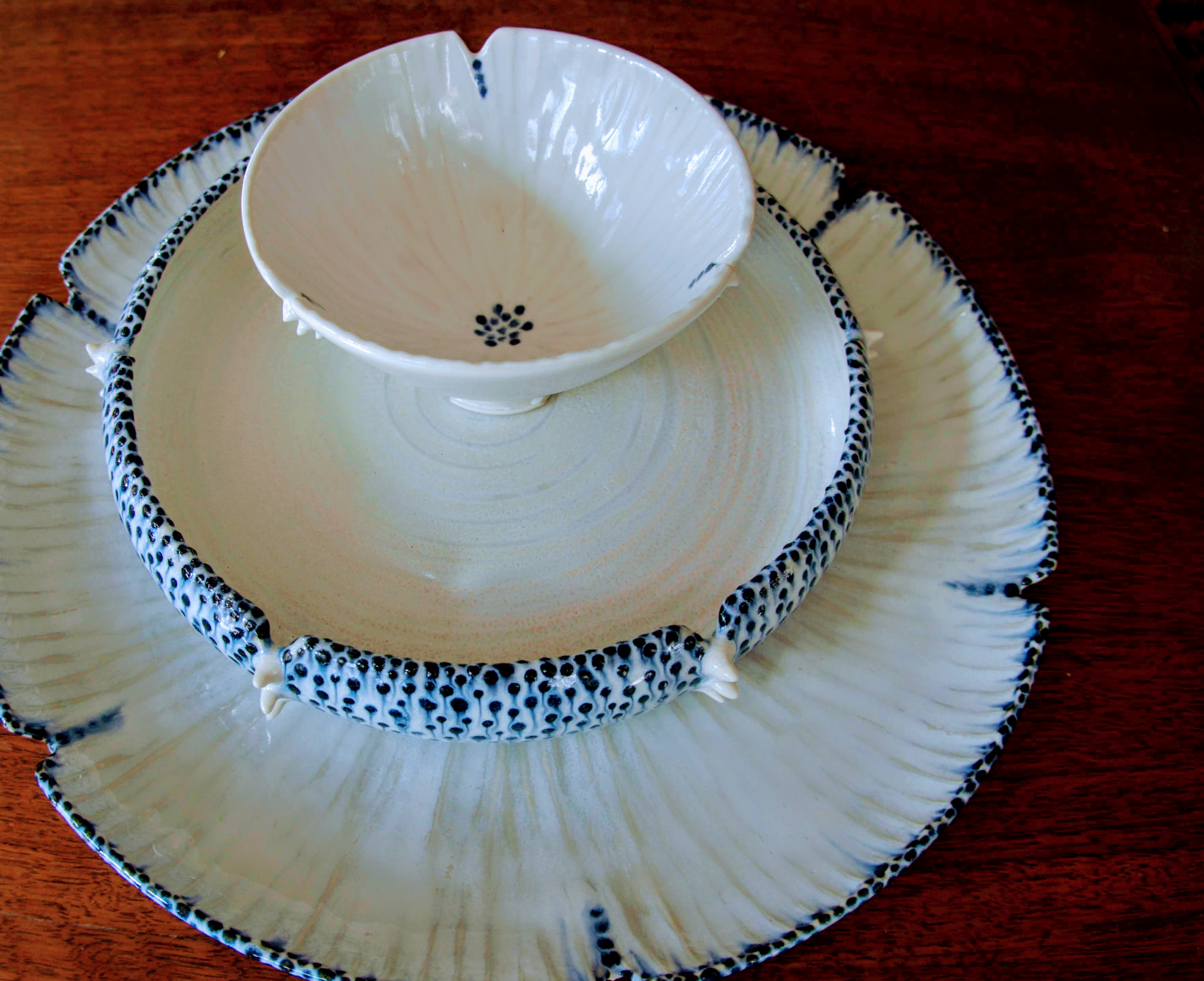 Tini Pinto’s bowl and plate set, dinner plate 11 in. (28 cm); salad bowl 8 in. (20 cm); condiment bowl 4 in. (10 cm) in diameter, wheel-thrown porcelain, fired to cone 6 in an electric kiln. 