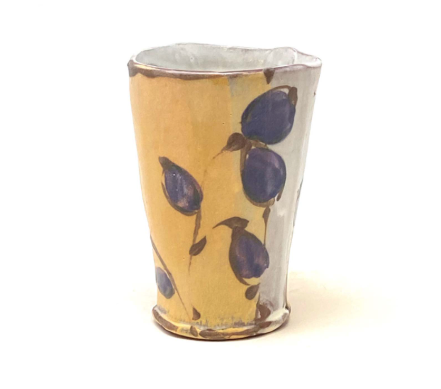 Susan McHenry, wine/juice cup with purple leaves, 4 in. (10 cm) in height, slab built red earthenware, colored slips, fired to cone 1 in oxidation, 2021.