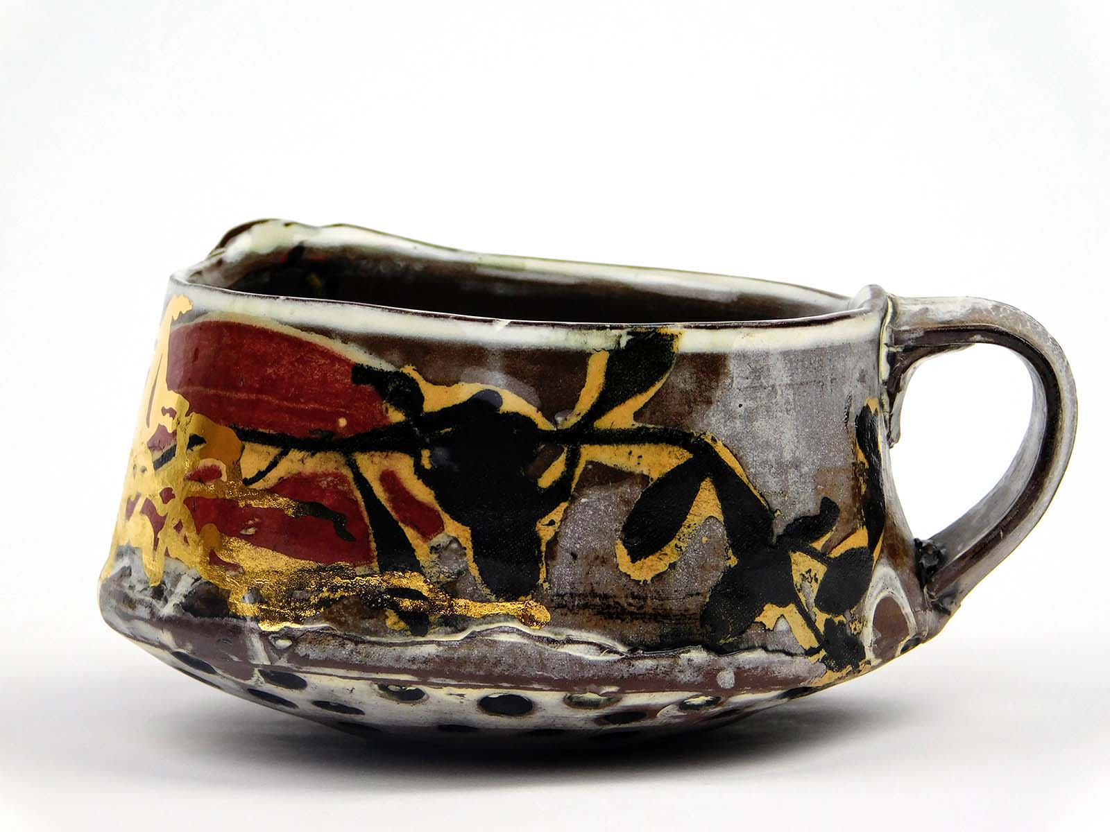 Breana Ferreira, Short Street mug, 5 in. (13 cm) in height, brown stoneware, white slip, Amaco underglaze, fired to cone 5 in an electric kiln, gold luster, 2021.