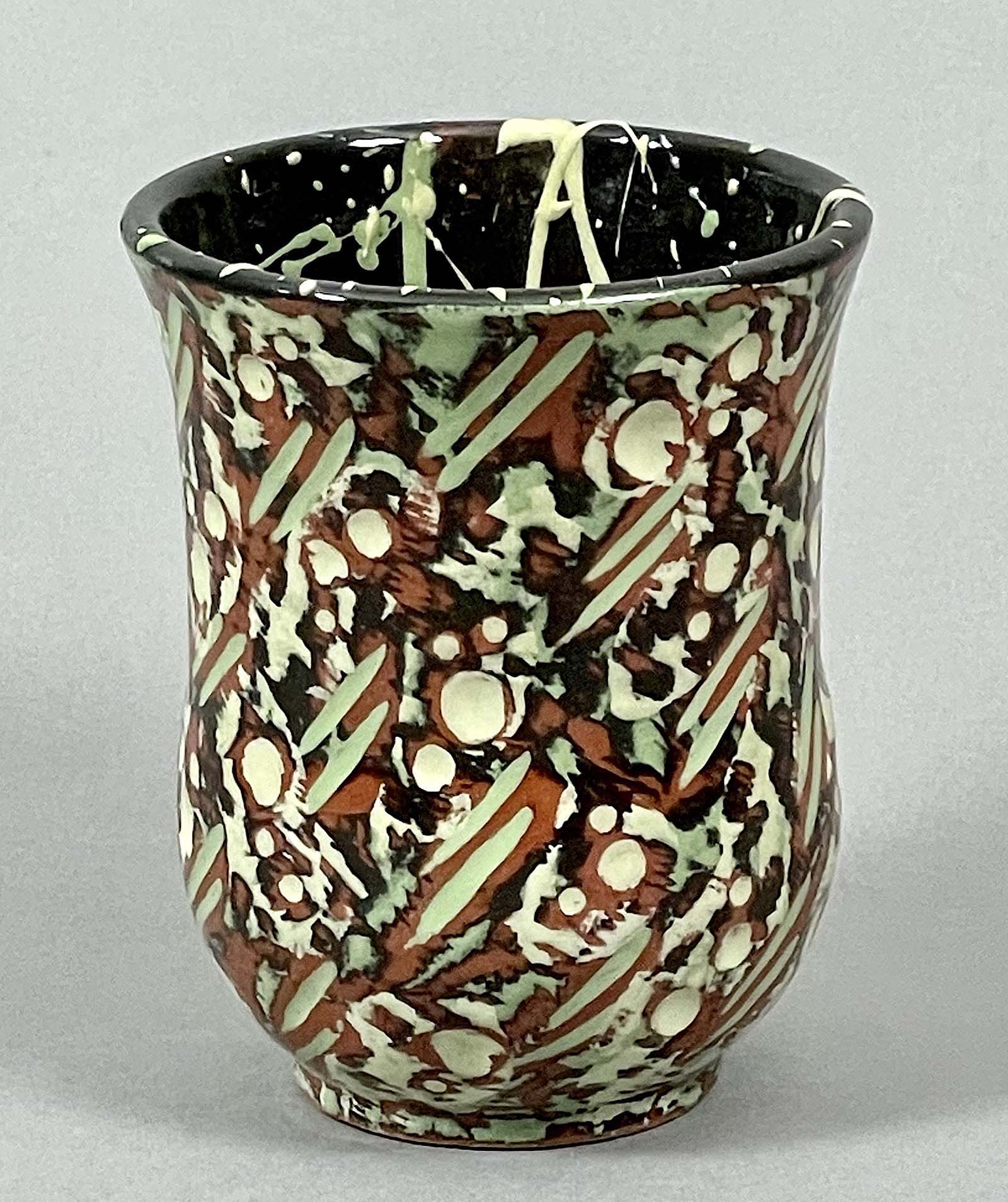 Swanica Ligtenberg, green cup, low-ﬁre red clay, engraved, colored slips, clear glaze, bisque fired cone 04, glaze fired to cone 05.