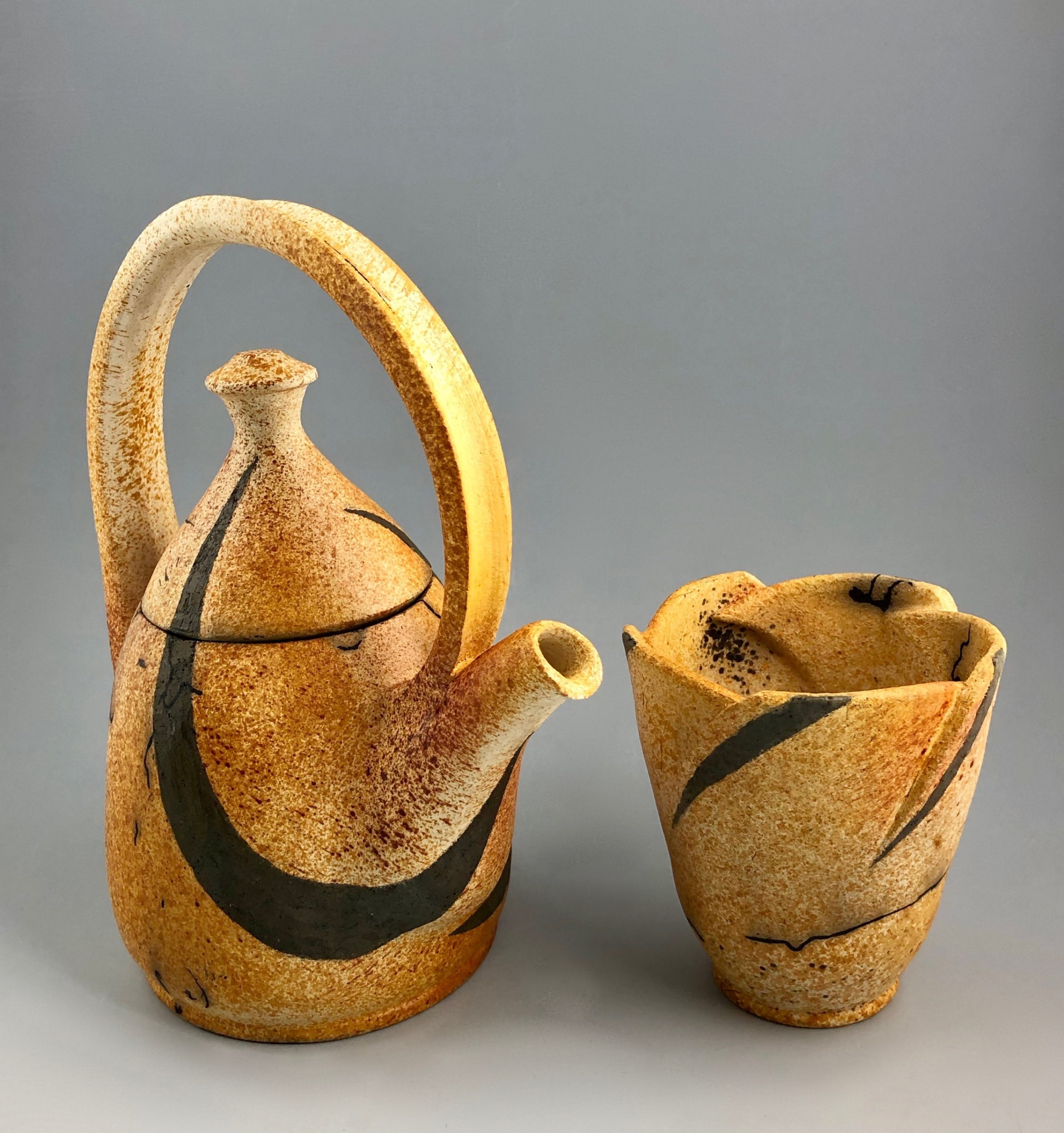 Swanica Ligtenberg, horsehair raku teapot set, 11 1/2 in. (29 cm) in height, high-fire white clay, black clay, mishima, bisque fired to cone 04, sugar, ferric chloride, raku fired to 1150°F. (621°C), horsehair, food-safe lacquer