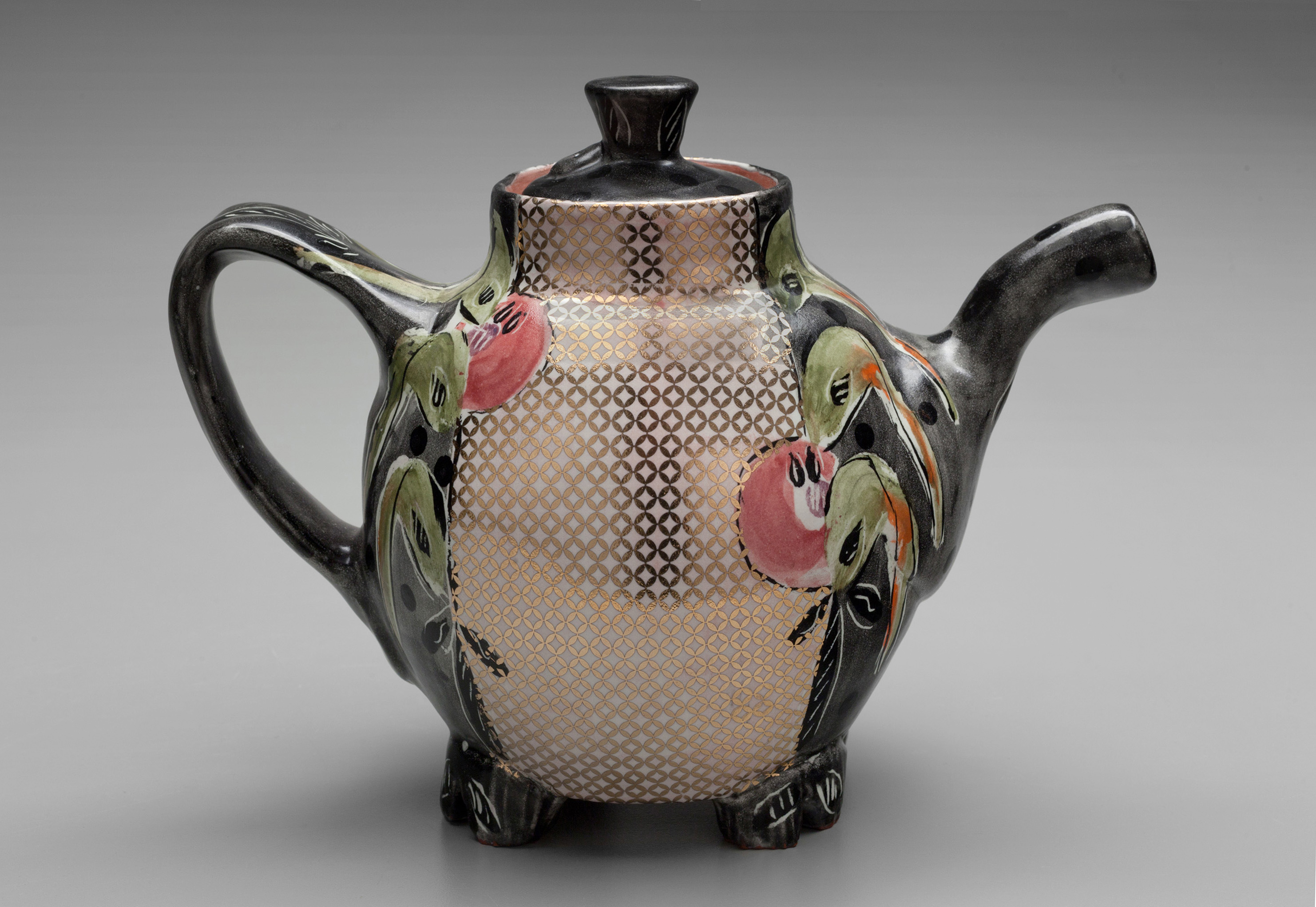 Posey Bacopoulos’ oval teapot, 9 in. (23 cm)in height, terra cotta, majolica, fired to cone 04 in an electric kiln, gold decals, decals, fired to cone 018, 2020.